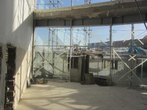 unitized curtain wall vs stick system