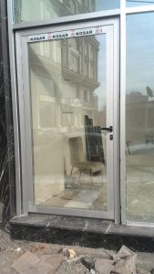 unitized curtain wall vs stick system